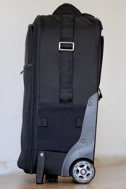 The right hand side has a strap that doubles as both a tripod holder and a handle to lift the bag.